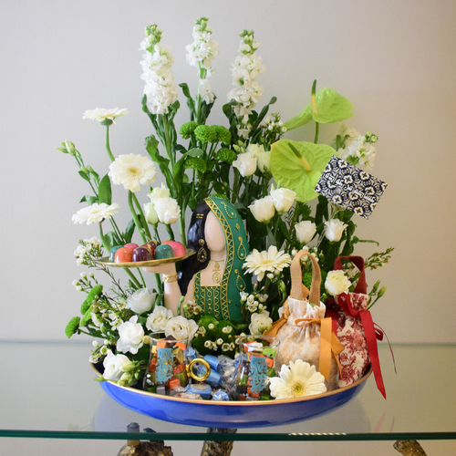 Omi el Ghalya - tray
  with Woman statue, 2 tea cups, 2 bag with chocolates and fresh anthorium,
  gerbera, matola and wax flowers.