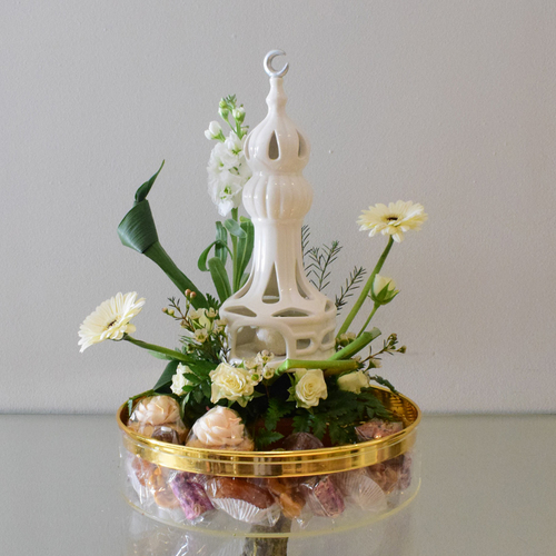 2026 - Ramadan 1 - ceramic
  mosque with round box of ramadan sweets, chocolates and a decoration of fresh
  white flowers like gerbera, matiola, wax flowers and baby roses.