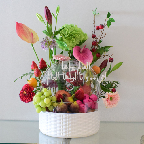 Mommy Fruits - white
  glass Bowl with cover with fresh decorated of mix fruits, chocolates and
  fresh & artificial flowers like anthorium,&nbsp; hydraengea,lilium, gerbera with written Eid
  Mubarak greetings.