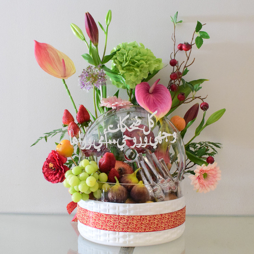 Mommy Fruits 2 - white
  glass Bowl with cover with fresh decorated of mix fruits, chocolates and
  fresh & artificial flowers like anthorium,&nbsp; hydraengea,lilium, gerbera with written Eid
  Mubarak greetings.