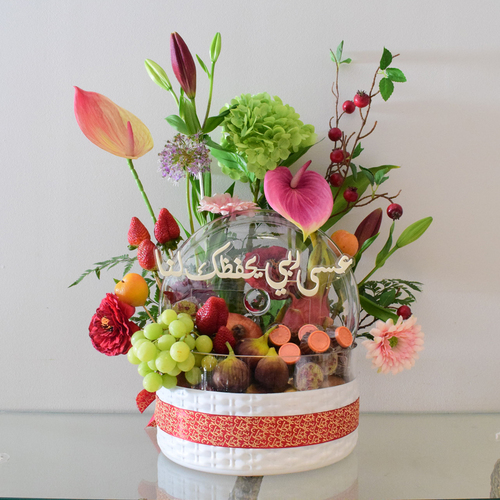 Mommy Fruits 3 - white
  glass Bowl with cover with fresh decorated of mix fruits, chocolates and
  fresh & artificial flowers like anthorium,&nbsp; hydraengea,lilium, gerbera with written Eid
  Mubarak greetings.