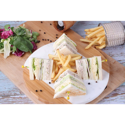 Zahra Club Sandwich - Triple-layered
  classic with special chicken mix, smoked turkey, egg, lettuce, and cucumber. Served with fries on the side.