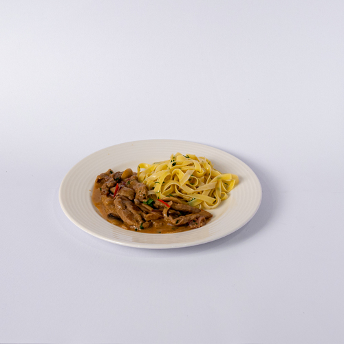 Beef Stroganoff with tagliattele - Creamy mushroom sauce with tender chicken strips served over egg noodles