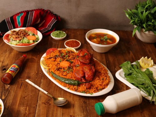 Chicken Kabsa Platter - Half chicken, served with red rice, maabouj and broth.