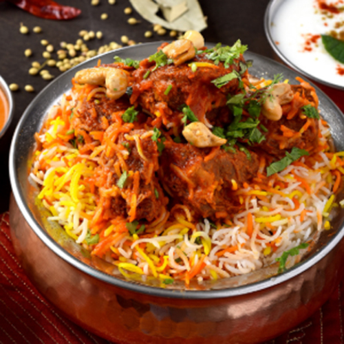 Mughlai lamb Biryani - An aromatic mixture of rice, lamb, saffron, herbs and spices, served with raita and light spicy gravy