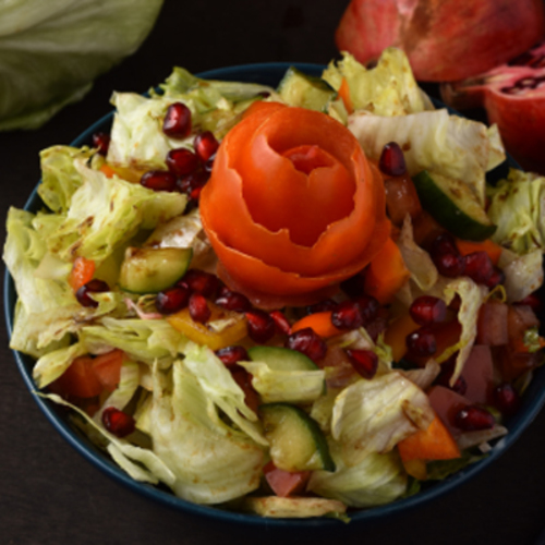 Pomegranate Salad - Romain lettuce ,homemade balsamic dressing ,croutons , on top Parmesan cheese