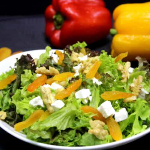 Amire Salad - Red oak leaf isolated lettuce, balsamic dressing, apricot, walnut on top feta cheese.