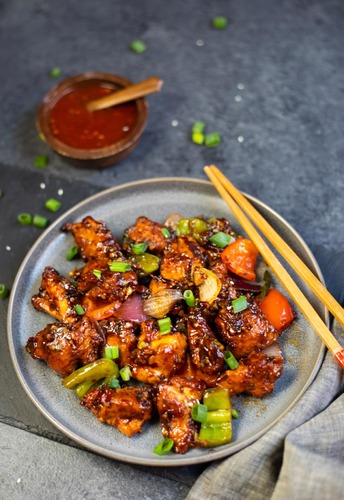 Chili Chicken - Crispy chicken breast pieces coated in delicious sweet chili sauce.