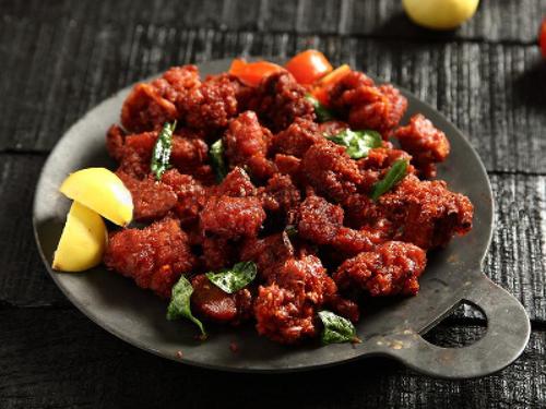 Chicken 65 - Chicken is first marinated in minimal spices, deep-fried, and then cooked and coated in yogurt and infused with flavors of curry leaves and green chilies.