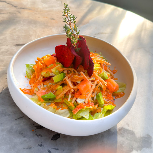 Salmon Avocado Salad - Lettuce, avocado, crab, and salmon, garnished with beetroot chips and our signature dressing.