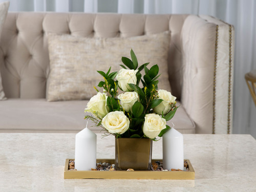 Twenty One - The arrangement contains mix of flowers and leaves with candles and stones.
Height: 30 cm, Width: 34 cm