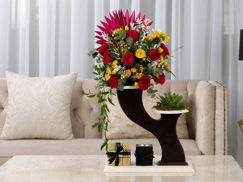 Titro - The arrangement contains a mix of flowers, Echeveria plant,  italian ruscus and dried decorations in addition to the Belgain chocolates and Mubkhar.
Height: 70 cm, Width: 20 cm