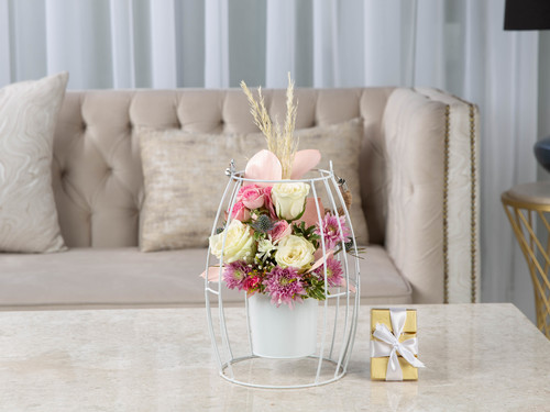 Rose House - The arrangement contains mix of flowers, gypsophilia, erengium, chrysanthemum, dried rice with leaves with Belgian chocolates.
Height: 35 cm, Width: 25 cm