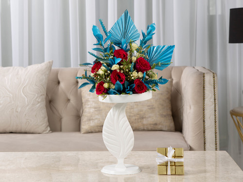 Blossoms - The arrangement contains a mix of flowers, italian ruscus and dried decorations in addition to the Belgain chocolates.
Height:67 cm Width: 20 cm