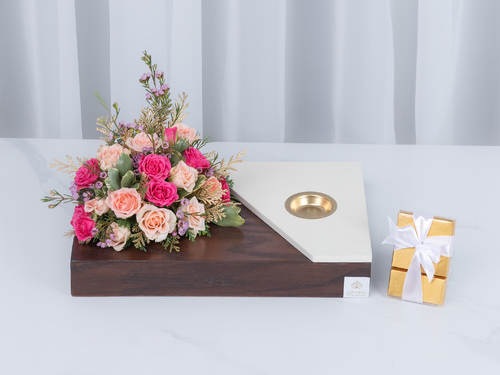 Aloft - This bouquet contains a mix of flowers on a wooden base which contains a mubkhar.
Height: 23 cm, Width: 35 cm