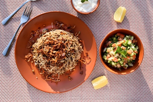 Mujadara - Mujadara served with fried onion, chopped salad