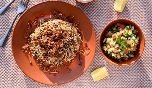 Mujadara - Mujadara served with fried onion, chopped salad