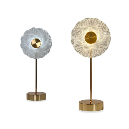 Pave Fancy Table Light, Gold & White 3235 - Redefine elegance in your home with this table light, where style meets utility in perfect harmony. This exquisite table light features a sturdy round base, providing stability when placed on any surface. The pole stem extends gracefully, supporting the light and adding a touch of minimalist charm. The intertwining geometric lines of the lampshade evoke a sense of movement and fluidity, lending depth and dimension to your room. Whether placed on a bedside table, a desk, or a living room side table, this light enhances the ambience with its soft, warm glow.