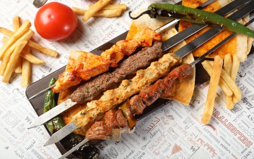 Mix Grill - Four skewers of mixed grill consisting of chicken kebab, meat kebab, tikka, and shish tawouk.