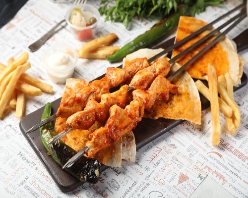 Shish Tawouk Plate - A plate of three skewers of Shish Tawouk with a Hatay turkey flavor, served with potatoes.