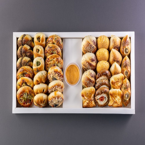 Serving pies - Assorted savory pastries with various fillings including cheese, spinach, and fresh pizza