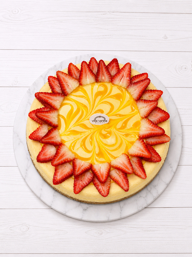 Mango cheesecake decorated with strawberries