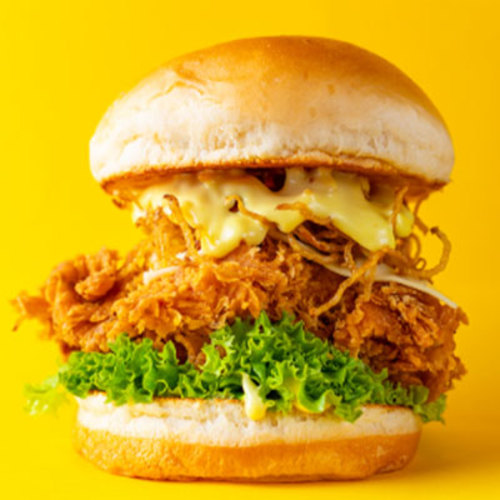 Crunchy Chicken Slider - Piece of soft fried chicken breast topped with white cheese and lettuce.