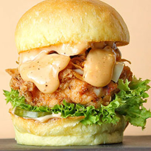 Smoke Chicken Slider - Piece of soft fried chicken breast topped with caramelized onion, white cheese and lettuce.