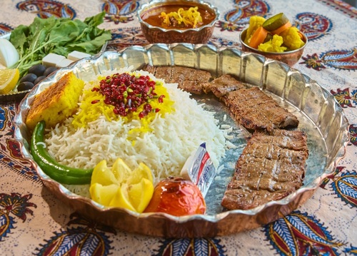 kebab Barak with rice - A meal consisting of 1 skewer of pure meat served with grilled tomatoes and rice