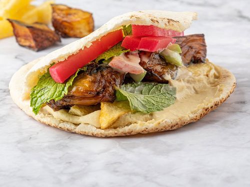 Super Falafel And Eggplants Sandwich - Falafel, eggplants , tahini, salad, pickles, mint and hummus.