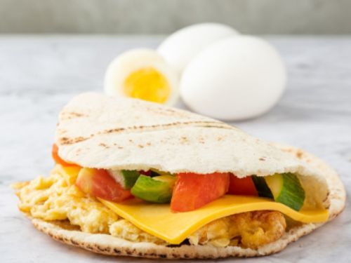 Super Eggs With Cheese Sandwich - Eggs with cheese, salad, pickles and mint.