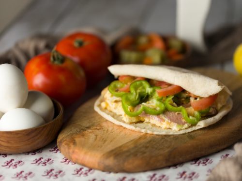 Mesh Bas Falafel - Super Eggs With Hot Dog Sandwich - Eggs, hot dog slices and salad.