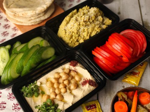 Mesh Bas Falafel - Mega Falafel Box - 850 grams falafel paste, tahini pack, 850 grams pickles, 850 grams tomatoes, cucumber, chili sauce pack, chili lemon sauce, 2 Lebanese bread bags, 2 sammon bread bags and large hummus platter