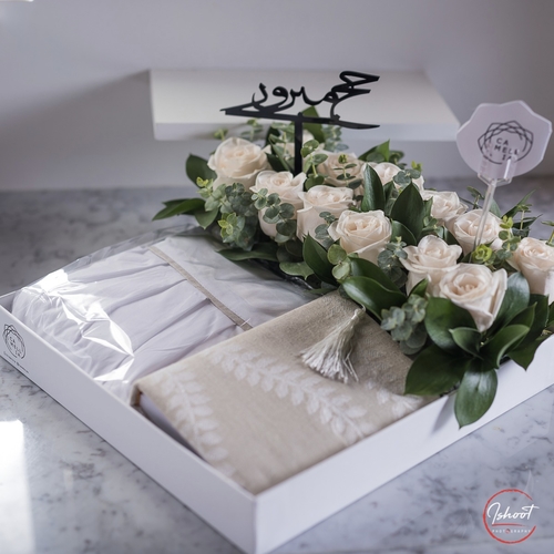 White Tray With pray dress and mus'haf decorated with natural white flower.