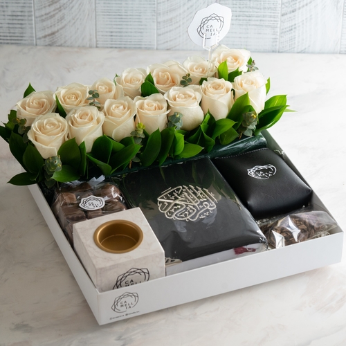 A White Tray Decorated With Natural White Roses Containing A Bag Of Chocolate, Incense, A censer And