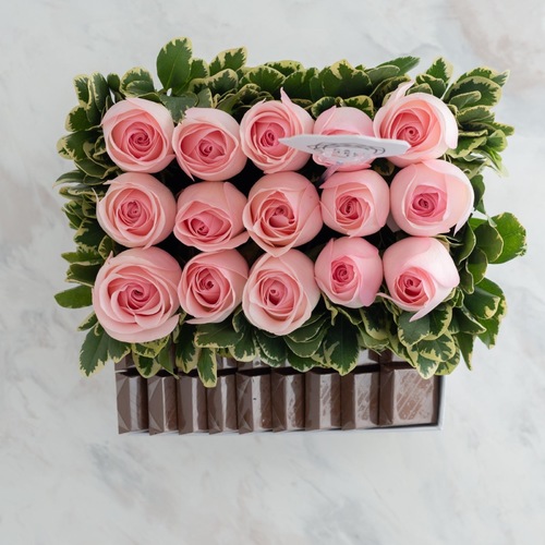 White box rose flowers with chocolate wafers