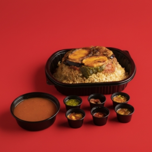 Meat Maqluba - A traditional dish made with assorted vegetables and tender meat pieces, layered with white rice and flipped upside down for a rich, irresistible flavor