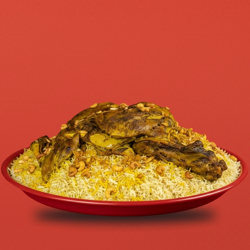Mini Ghozi Tray - Emberech Mini Ghozi tray serving (3–4) persons, featuring a tender piece of Australian lamb with fluffy rice, nuts, Kuwaiti stuffing, Adani fat, and served with Daqoos, Mabooj, and Achar