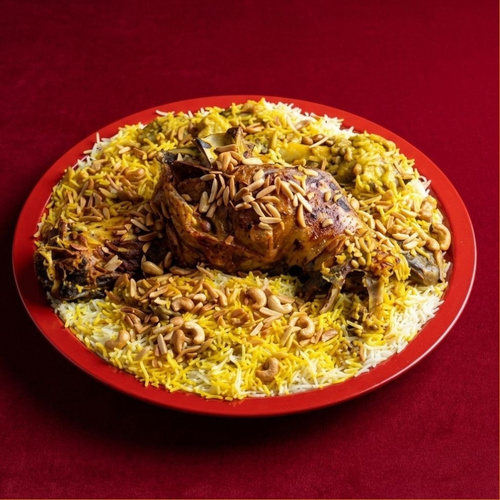 Mini Ghozi Tray - A mini Ghozi tray from Emberech, serving 3–4 people. It features a tender, well-held piece of Australian lamb served with fluffy traditional rice, nuts, Kuwaiti stuffing, and premium “Adani” ghee. It is accompanied by daqoos, maabooj, and pickles. (Requires 4 hours preparation).