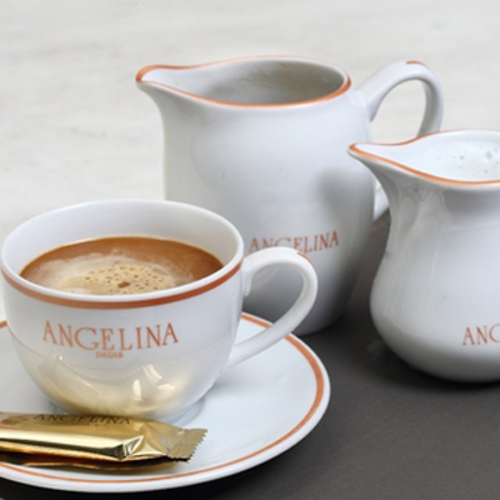 Café au lait - Cup of coffee with steamed milk on the side.