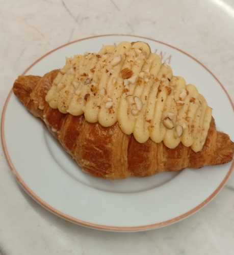 Almond Croissant - Croissant filled with almond paste and topped with crushed almonds.