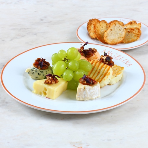 Selection of cheese - Roquefort, Emmental, goat cheese, bri and parmesan. Served with candied walnuts, grapes, selection of bread.