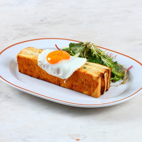 Croque-Madame - Smoked turkey, fried egg, Mozzarella and Emmental cheese, frizzy lettuce, béchamel, Dijon mustard.