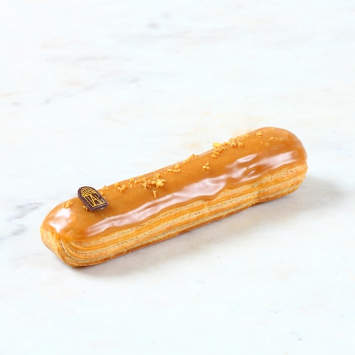 Éclair caramel - creation for the ÉCLAIR's lovers,&nbsp;Delicious&nbsp;choux pastry with creamy filling topped with caramel&nbsp;and crumble.