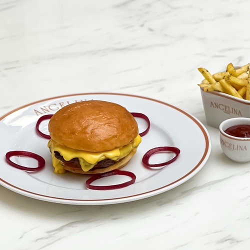 Angelina's cheese burger - Beef burger, cheddar cheese sauce onions pickles ring,grilled tomatoes ,French fries