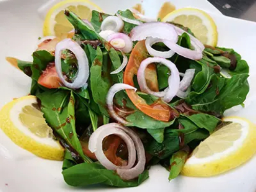 Rocca Salad - Rocca, tomato, onion, olive oil, lemon and pomegranate seeds