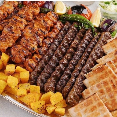 Large Jat Mix Grill - 6 kebab skewers, 24 pieces shish tawook, 2 arayes, and whole chicken served with French fries, Iranian bread, and 3 mini salads.