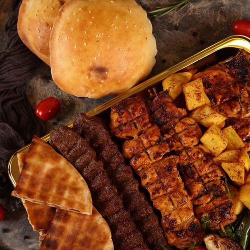 Medium Jat Mix Grill - Selectio from grills 4 kebab skewers 16 pieces of shish tawouk Half chicken grilled on coal Brides served with Iranian fries and breads Hummus, salad