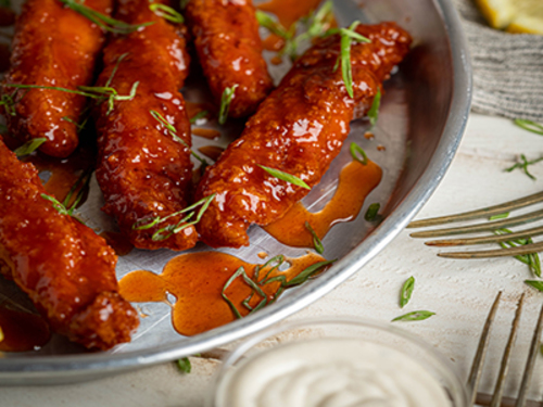 Buffalo Chicken Tender - Breaded chicken tender mixed with buffalo sauce and served with ranch sauce.