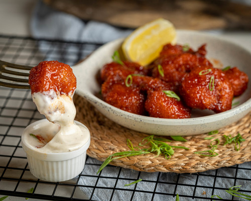 Buffalo Chicken Wings - Fried chicken wings mixed with buffalo sauce and served with ranch sauce.